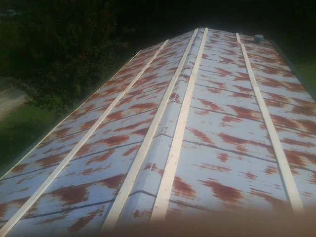 Rusted metal roof panels with new wood purlins before replacement — Storm Damage Roof Repair in Centralia by Roofing Brothers